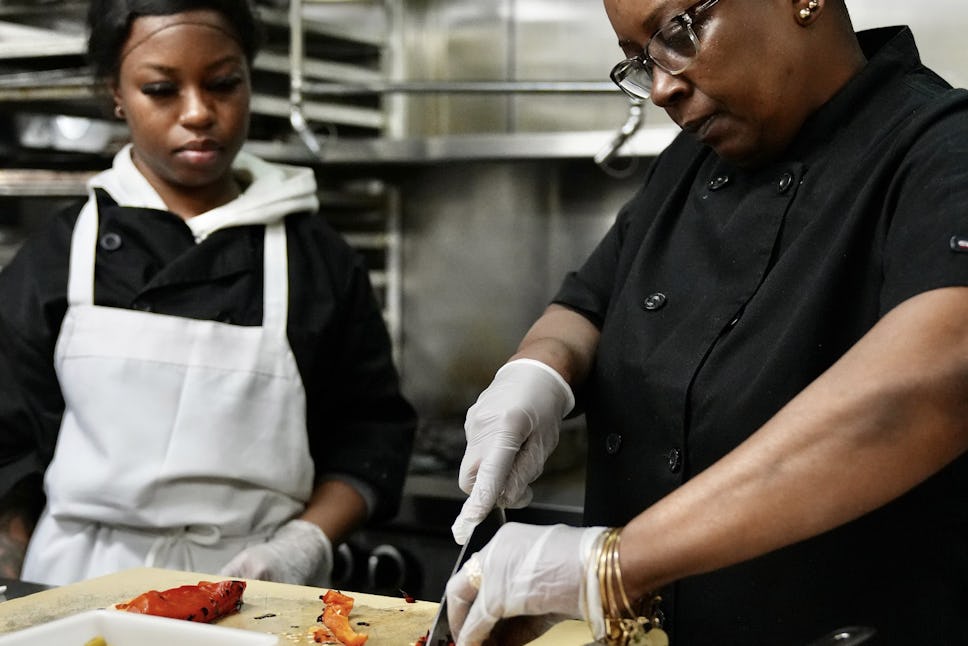 Chef Stacy doing a hands-on demonstration for a crew member.