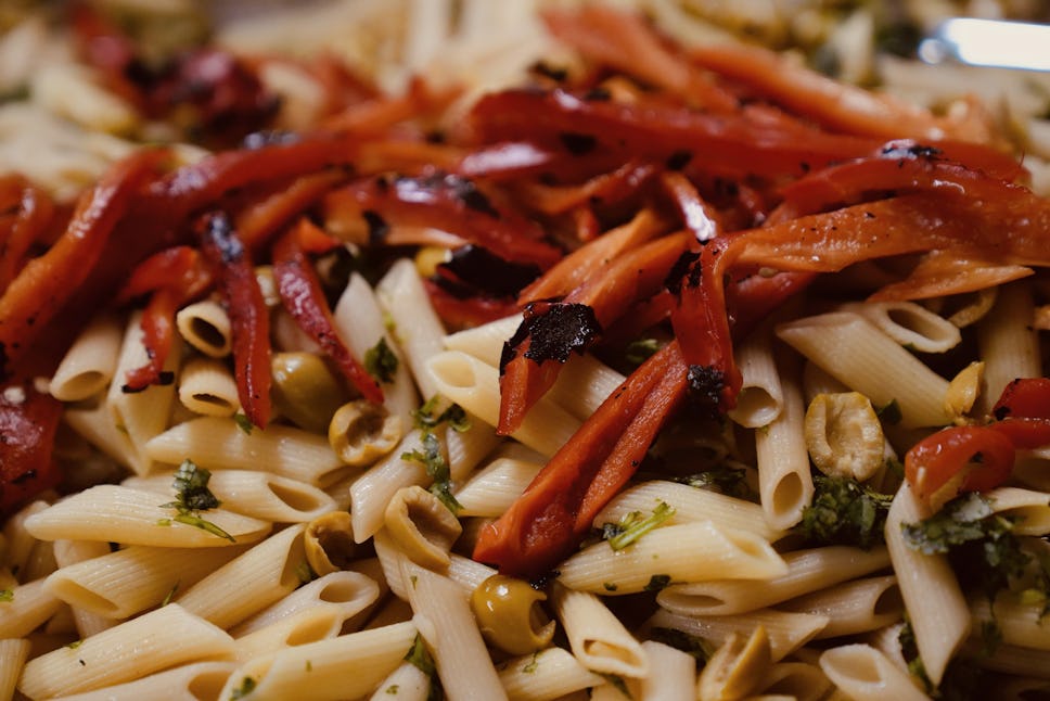 Pasta salad being prepped by crew members for our community dinner service to Door youth members, served daily Monday through Friday.